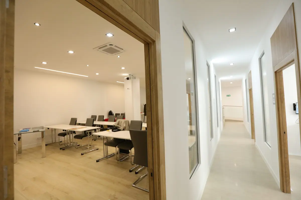 The classroom, with individual desks and a view down the corridor